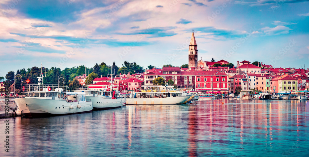 Fototapeta premium Panoramic evening cityscape of old fishing town Isola. Colorful summer seascape of Adriatic Sea. Beautiful outdoor scene of Slovenia, Europe. Traveling concept background.