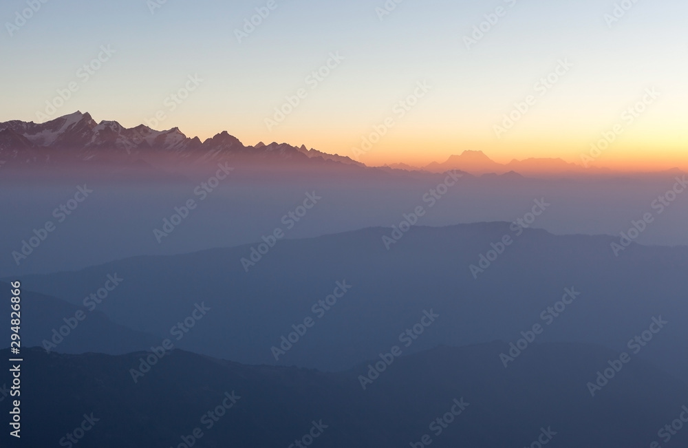 Misty landscape in himalayas. Foggy mountain ridges on sunrise. Beautiful view on everest base camp trail.