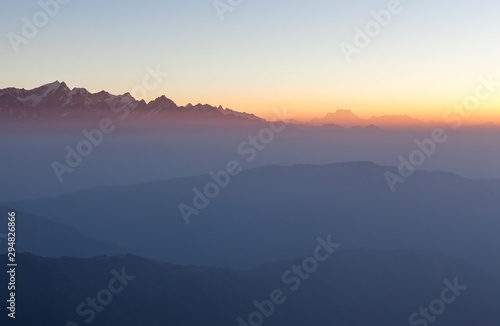 Misty landscape in himalayas. Foggy mountain ridges on sunrise. Beautiful view on everest base camp trail.