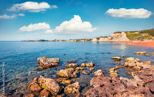 Picturesque spring landscape of famous Xi Beach. Colorful morning scene of Cephalonia island, Greece, Europe. Attractive seascape of Ionian Sea. Traveling concept background.