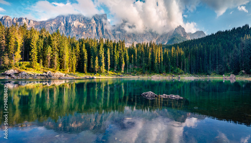 Attractive summer view of Carezza (Karersee) lake. Amazing morning scene of Dolomiti Alps, Province of Bolzano, South Tyrol, Italy, Europe. Beauty of nature concept background.