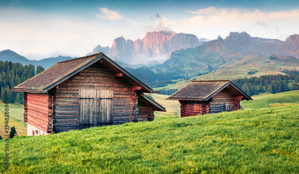Misty morning scene of Compaccio village, Seiser Alm or Alpe di Siusi location, Bolzano province, South Tyrol, Italy, Europe. Picturesque summer view of Dolomiti Alps. Misty morning scene of Compaccio village, Seiser Alm or Alpe di Siusi location, Bolzano province, South Tyrol, Italy, Europe. Picturesque summer view of Dolomiti Alps.