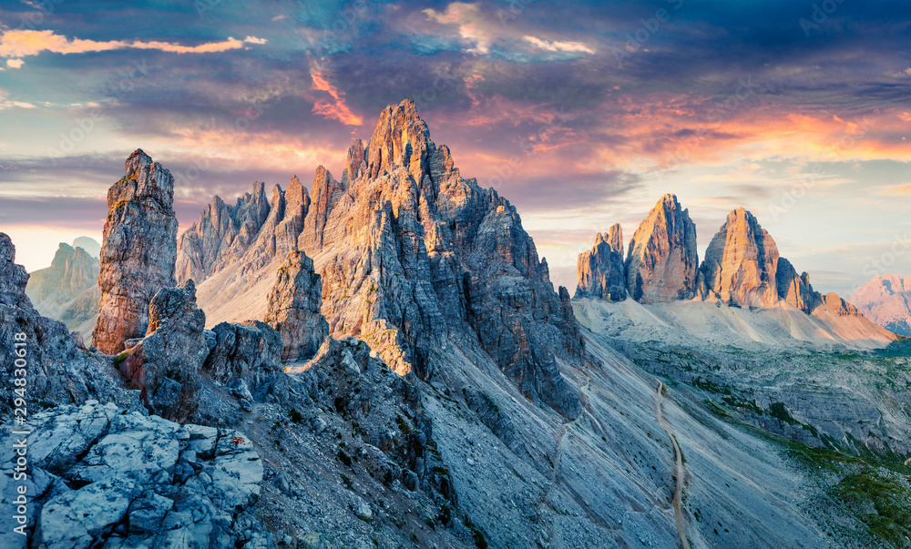 Unbelievable morning view of Paternkofel and Tre Cime Di Lavaredo mpountain peaks. Wonderful summer sunset in Dolomiti Alps, South Tyrol, Italy, Europe. Beauty of nature concept background.