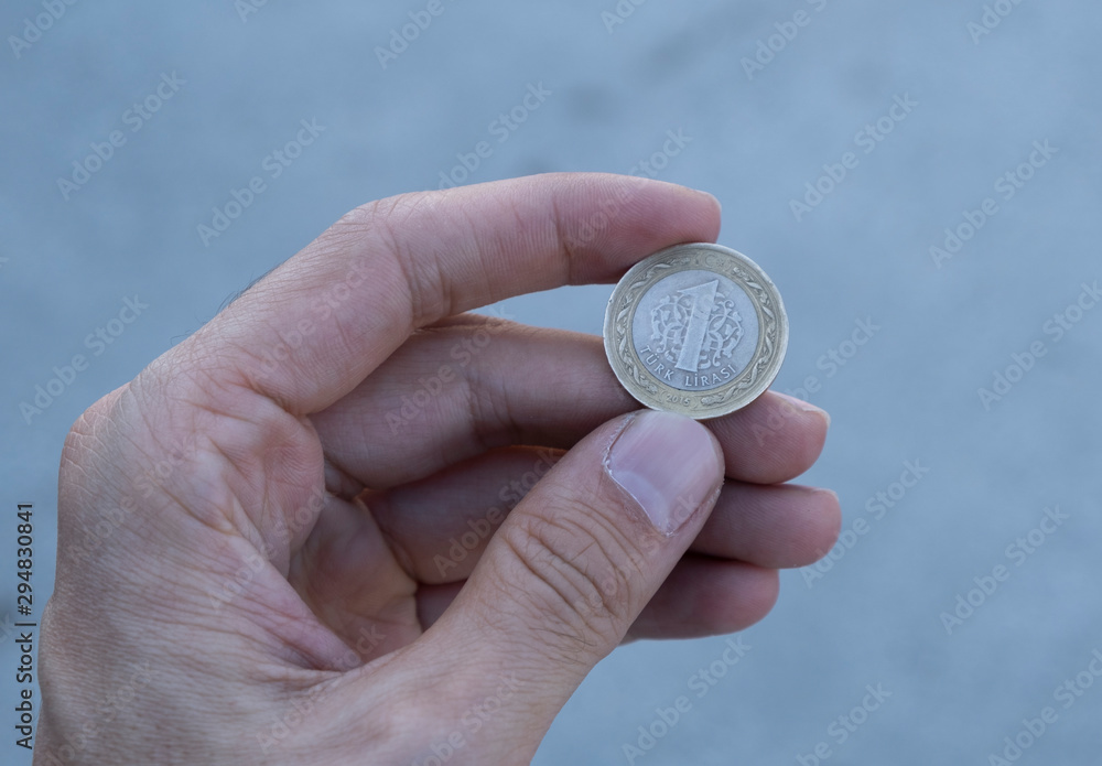 Turkish coin on hand , man holding turkish lira Turkish coin on hand , man holding turkish lira