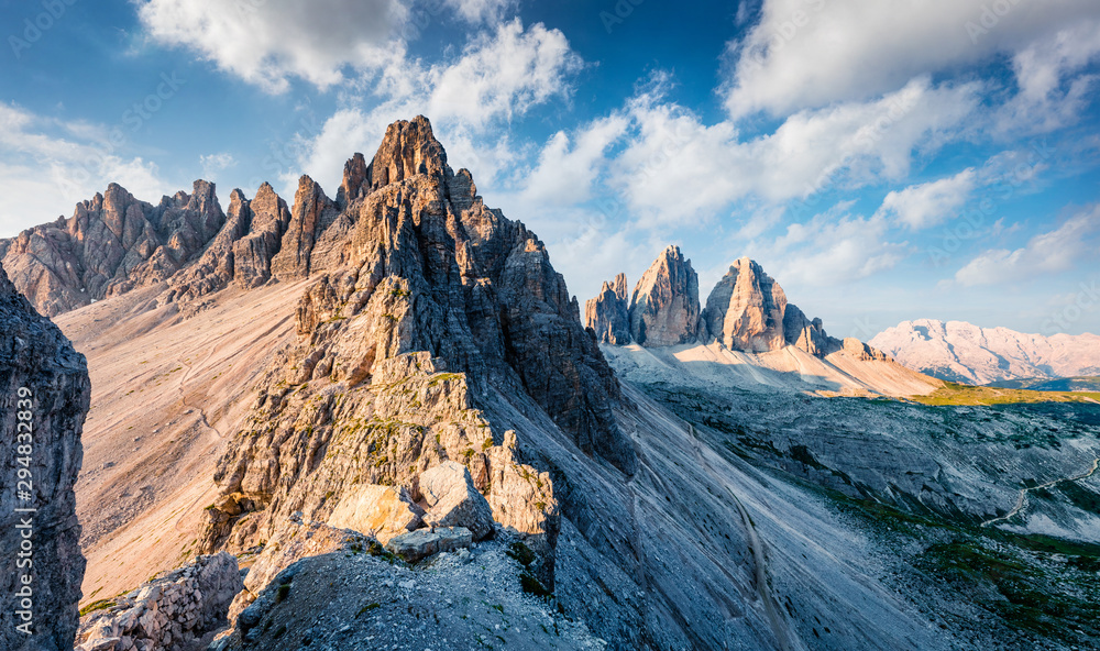 Captivating morning view of Paternkofel and Tre Cime Di Lavaredo mpountain peaks. Majestic summer scene of Dolomiti Alps, South Tyrol, Italy, Europe. Beauty of nature concept background.