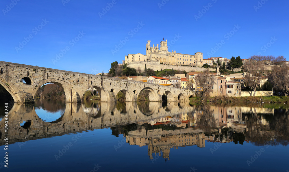Landscapes of France. Beziers city, Occitanie region. Ancient bridge and cathedral, reflection