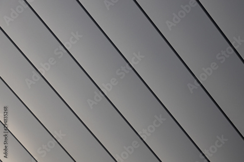 Close-up of smooth shiny grey siding wall of building
