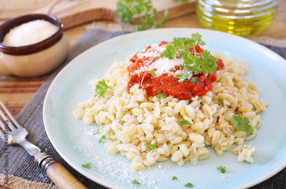 Pearl barley with tomato sauce and grated parmesan cheese Pearl barley with tomato sauce and grated parmesan cheese