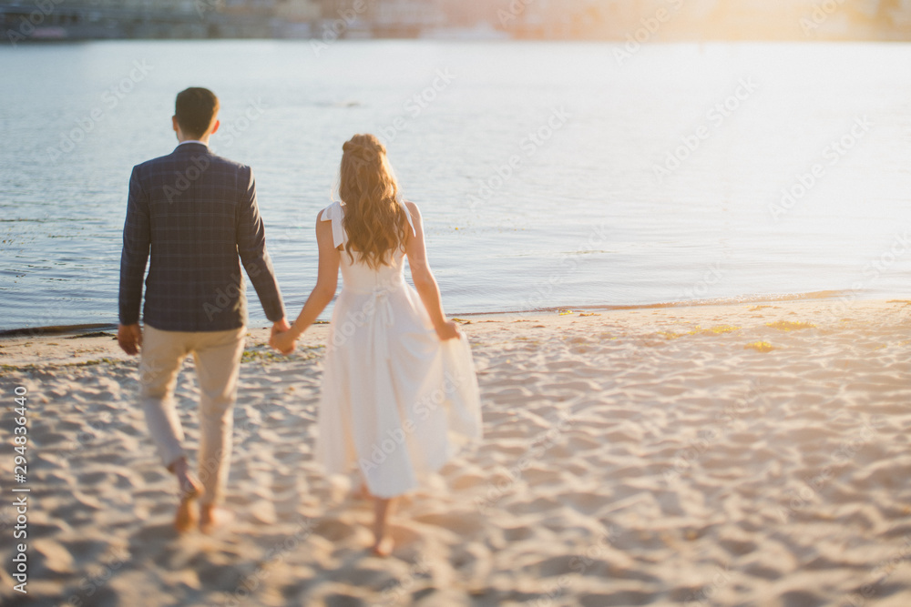 Love on wedding day. Stylish caucasian bride and groom from the back. Love on wedding day. Stylish caucasian bride and groom from the back.