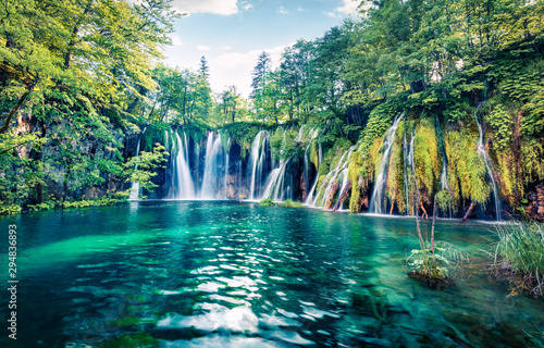 Fresh morning view of pure water waterfall in Plitvice National Park. Picturesque spring scene of green forest with small lake, Croatia, Europe. Beauty of nature concept background.