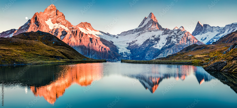 Fantastic evening panorama of Bachalp lake / Bachalpsee, Switzerland. Picturesque autumn sunset in Swiss alps, Grindelwald, Bernese Oberland, Europe. Beauty of nature concept background..