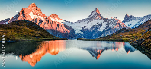 Fantastic evening panorama of Bachalp lake / Bachalpsee, Switzerland. Picturesque autumn sunset in Swiss alps, Grindelwald, Bernese Oberland, Europe. Beauty of nature concept background..