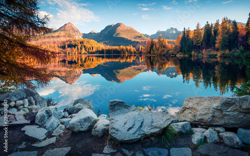 Attractive autumn view of Strbske pleso lake. Calm morning scene of High Tatras National Park, Slovakia, Europe. Beauty of nature concept background. photo
