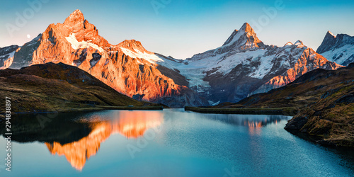 Breathtaking evening panorama of Bachalp lake/Bachalpsee, Switzerland. Exciting autumn sunset in Swiss alps, Grindelwald, Bernese Oberland, Europe. Beauty of nature concept background. photo