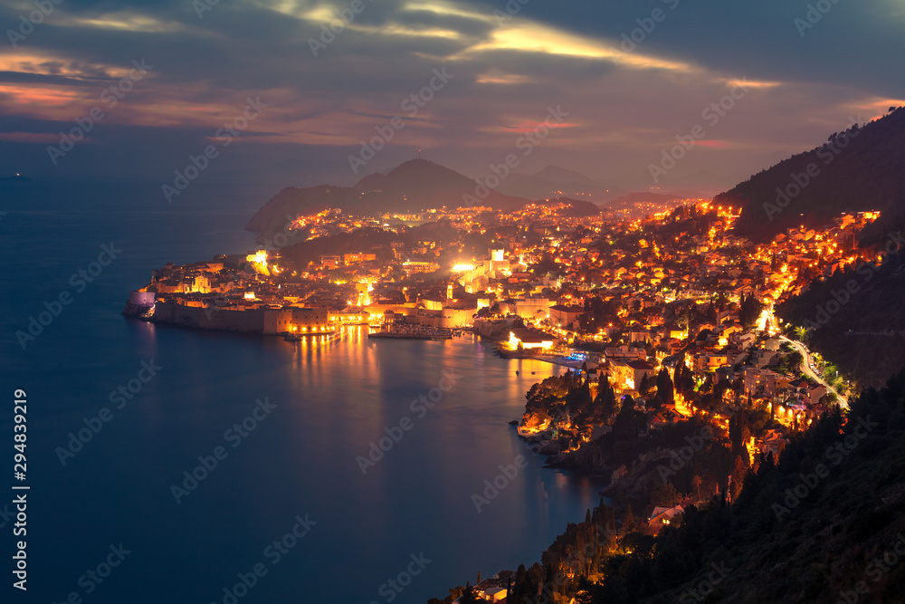 Aerial night view of Dubrovnik city. Great summer sunset in Croatia, Europe. Beautiful world of Mediterranean countries. Traveling concept background.