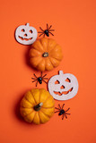Orange halloween background with pumpkins and spiders
