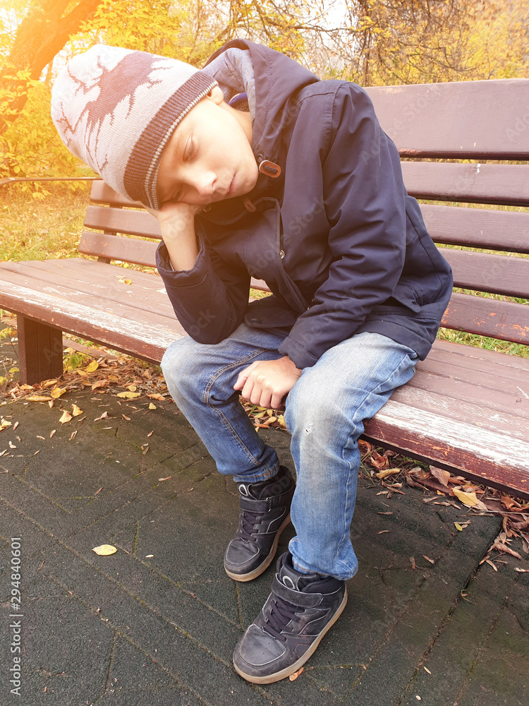 sad boy sitting on bench alone outdoor sad boy sitting on bench alone outdoor