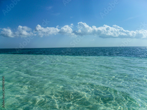 View of the shallow water and the transition to depth in the Caribbean on a sunny summer day.