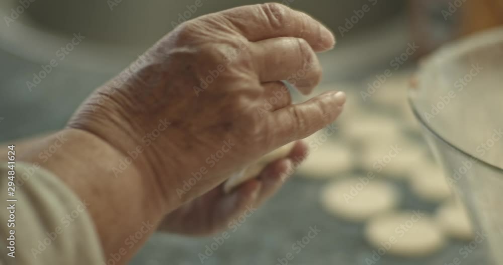 Grandmother makes a traditional Russian dish of dumplings, pelmeni, close-up Grandmother makes a traditional Russian dish of dumplings, pelmeni, close-up