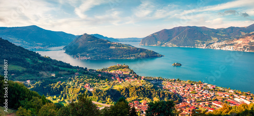 Fototapeta Naklejka Na Ścianę i Meble -  Aerial summer view of Iseo lake. Splendid morning cityscape of Marone town with Monte Isola island, Province of Brescia, Italy, Europe. Traveling concept background.