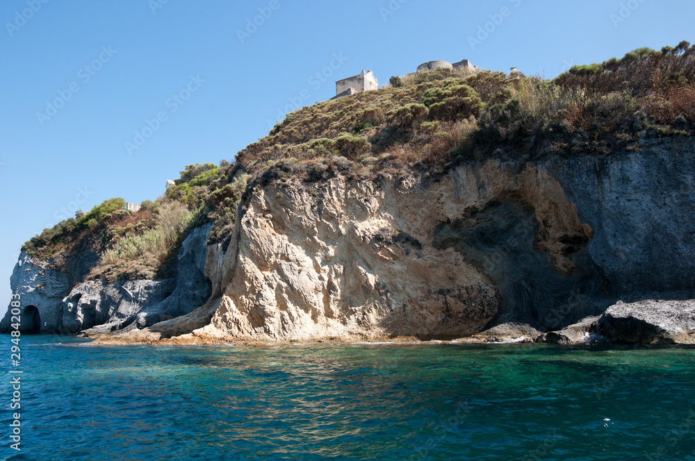 Landscape of the rocky cliff of the island of Ponza. Rocky shore of the famous island of volcanic origin of the central Italy.