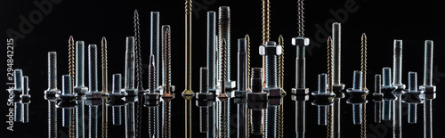 panoramic shot of diverse spotless metallic screws isolated on black photo