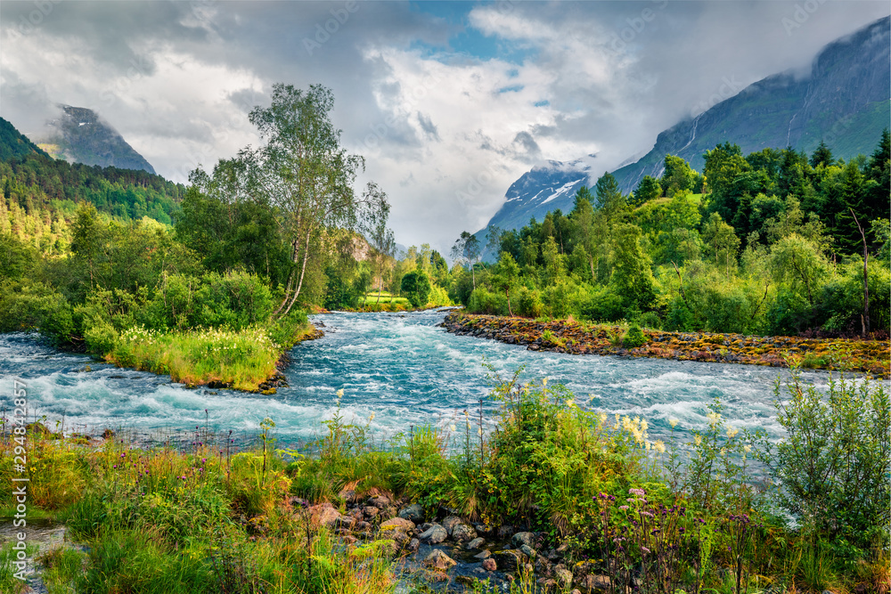 Picturesque summer view of Loelva river, located near Loen village, municipality of Stryn, Sogn og Fjordane county, Norway. Colorful sunny scene in Norway. Beauty of nature concept background.