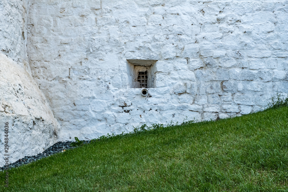 Fototapeta premium Stone wall with a small window. Kazan Kremlin