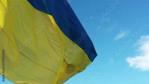 4k Ukrainian yellow blue flag, blue sky background, closeup, photo