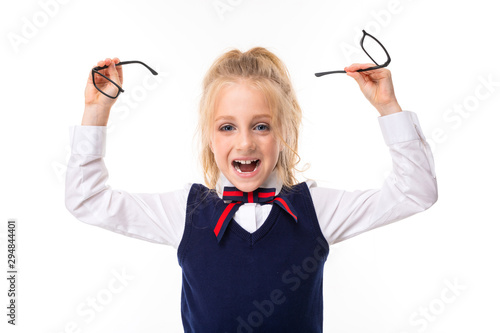 Quadro em tela A little girl with blond hair stuffed in a horse tail, large blue eyes and a cute face broke her glasses