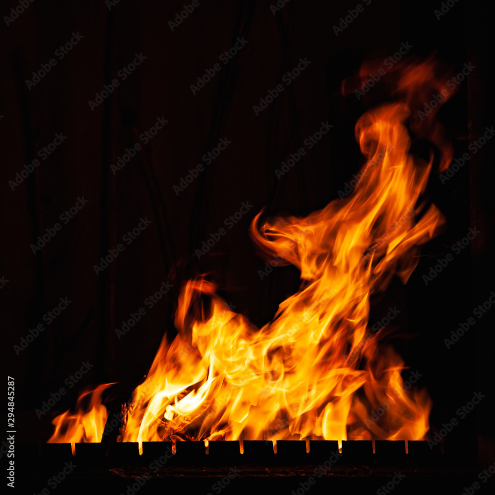 Fire. Bright burning fire at night. A fire in the grill, fireplace and hearth. Fire. Bright burning fire at night. A fire in the grill, fireplace and hearth.