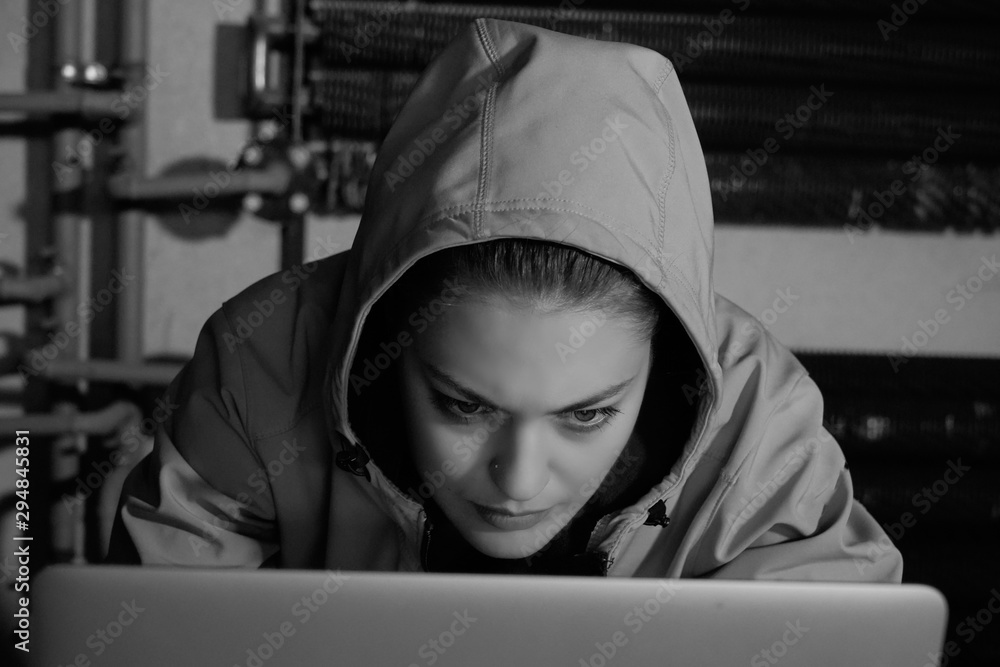Young Female Hacker Breaks into Corporate Data Servers from His Underground Hideout. Place Has Dark Atmosphere - Image Young Female Hacker Breaks into Corporate Data Servers from His Underground Hideout. Place Has Dark Atmosphere - Image