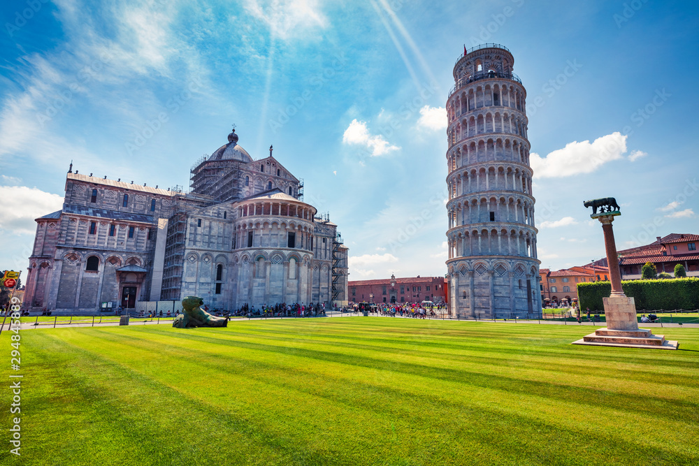 Splendid summer view of famous Leaning Tower in Pisa. Colorful morning scene with hundreds of tourists in Piazza dei Miracoli (Square of Miracles), Italy, Europe. Traveling concept background.