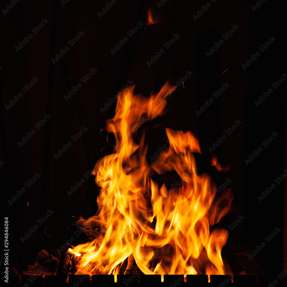 Fire flames. Beautiful bright burning fire at night. A fire in the grill, fireplace and hearth. Fire flames. Beautiful bright burning fire at night. A fire in the grill, fireplace and hearth.