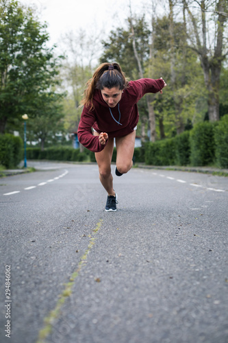Wallpaper Mural Fast powerful young woman sprinting. Running training on urban suburbs road. Torontodigital.ca