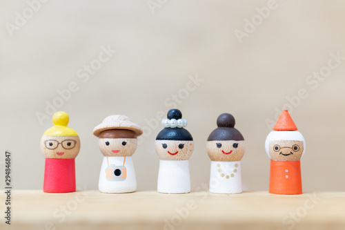 Miniature toy : cute wooden doll with  happy face on wooden background Fototapeta