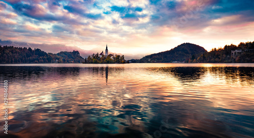 Panoramic morning view of Pilgrimage Church of the Assumption of Maria. Breathtaking autumn scene of Bled lake, Julian Alps, Slovenia, Europe. Traveling concept background.