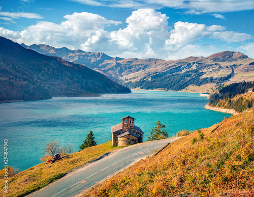 Picturesque morning view of Roselend lake/Lac de Roselend. Sunny autumn scene of Auvergne-Rhone-Alpes, France, Europe. Beauty of nature concept background. photo