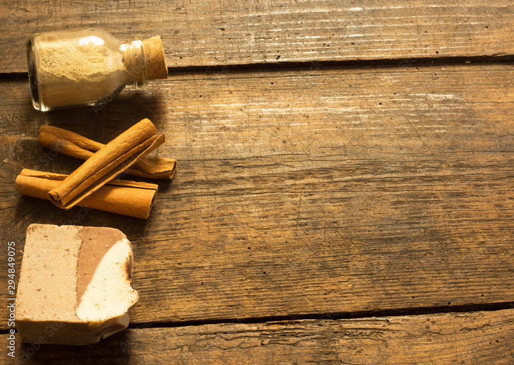 Natural handmade soap with cocoa and cinnamon on wooden background and copy space Natural handmade soap with cocoa and cinnamon on wooden background and copy space