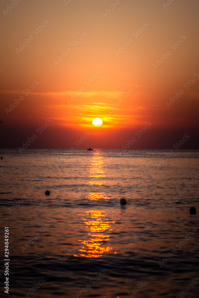 Summer sea sunset in Greece. Fisherman in boat.