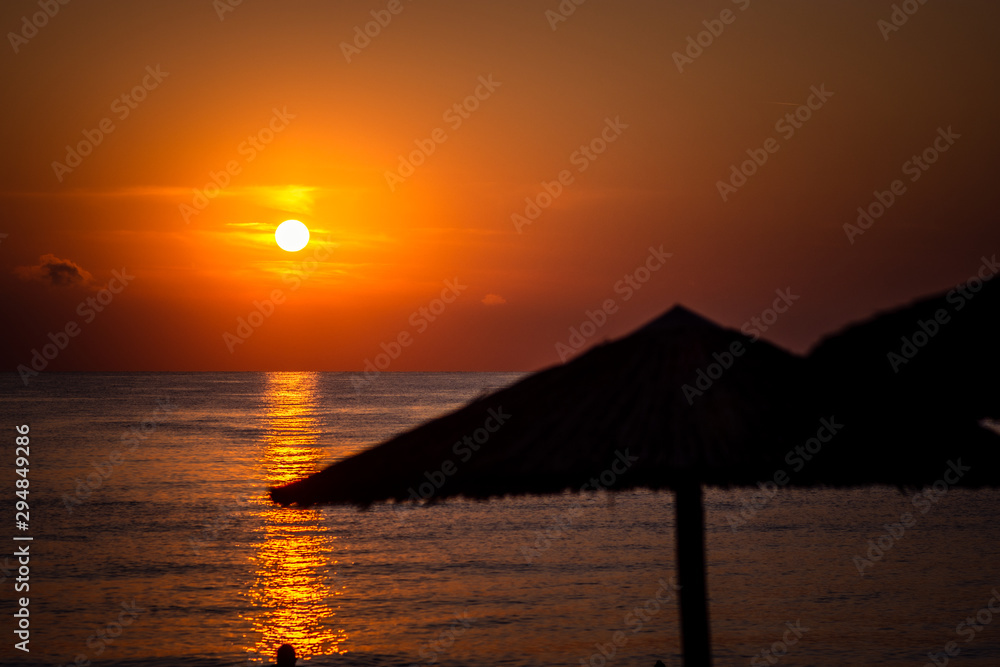 Summer sea sunset in Greece. Fisherman in boat.