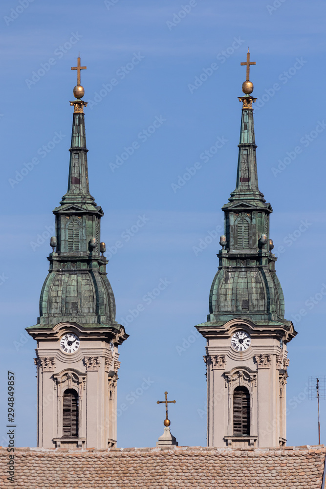 Two spiers of the clock towers and a cross of the old Orthodox E