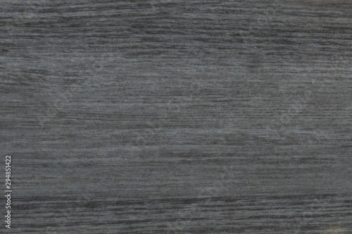 Dark grey wood texture background surface with natural pattern and horizontal strokes.
