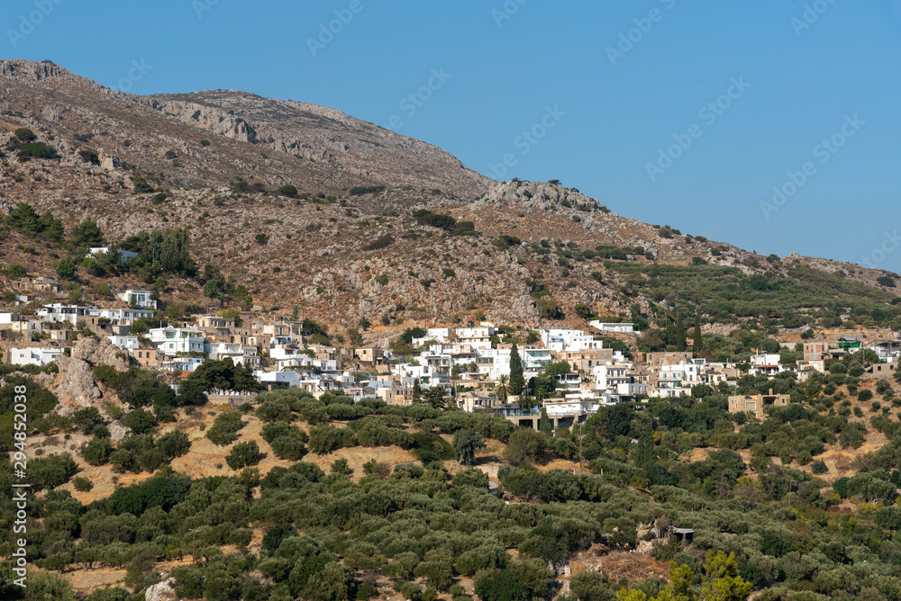 Mountain village of  Pefki seen from Agios Stefanos road, Crete, Greece. September 2019.  The mountainside ancient village of Agios Stefanos one of the oldest in Crete.