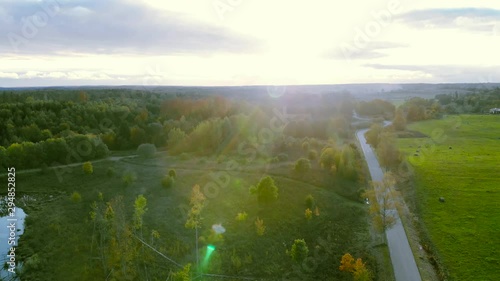 Descending drone aerial shot of beautiful rural landscapem, during sun ist shining and dazzling. photo