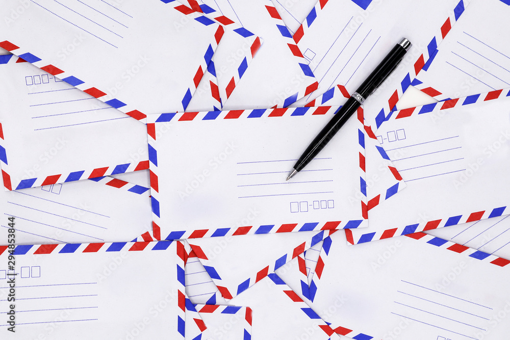 airmail envelopes and a black pen on white office desk. airmail envelopes and a black pen on white office desk.