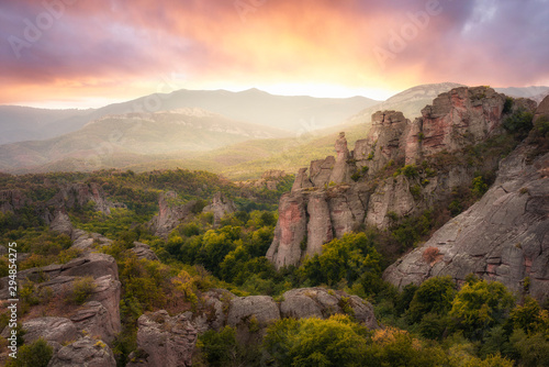 The amazing  Belogradchik rocks at sunset.  Beautiful landscape with bizarre rock formations. Nature gem landmark. Magnificent panoramic sunset view in Bulgaria. 