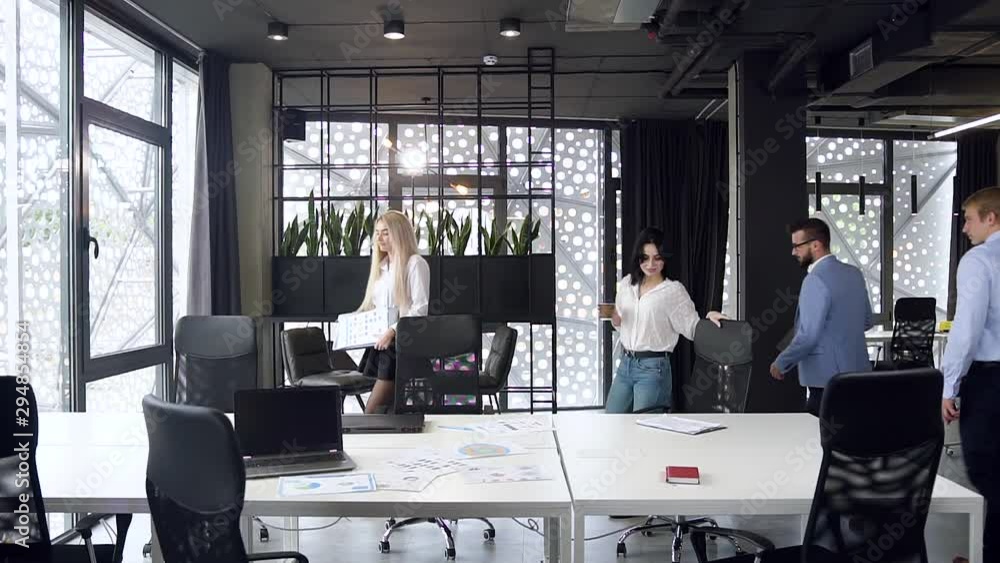 Slow motion of mixed races pleasant bright business colleagues working in the meeting room with different paper report and table laptop Slow motion of mixed races pleasant bright business colleagues working in the meeting room with different paper report and table laptop