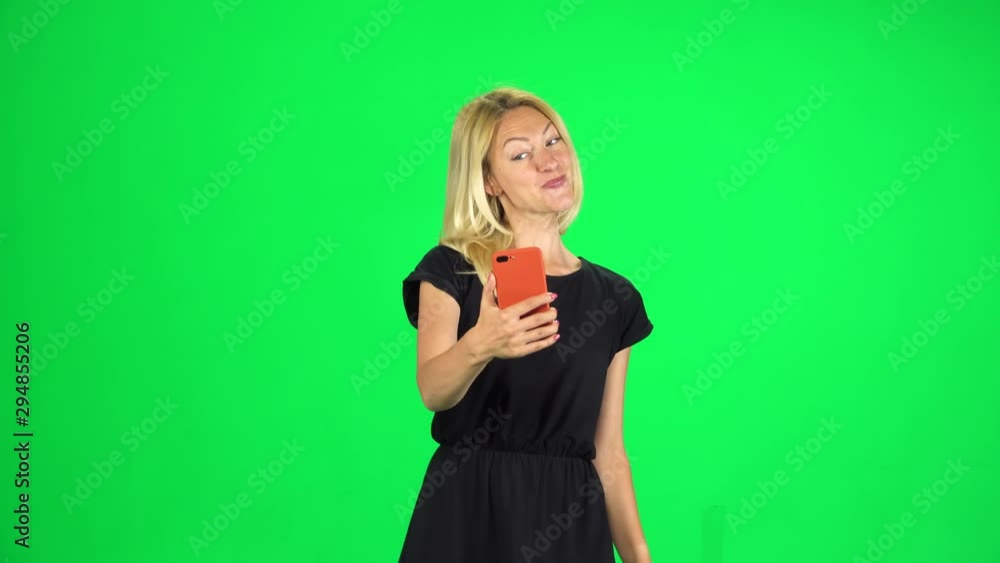 Girl tourist goes and takes a selfie, then looks through the photos on the smartphone. Chroma Key Girl tourist goes and takes a selfie, then looks through the photos on the smartphone. Chroma Key