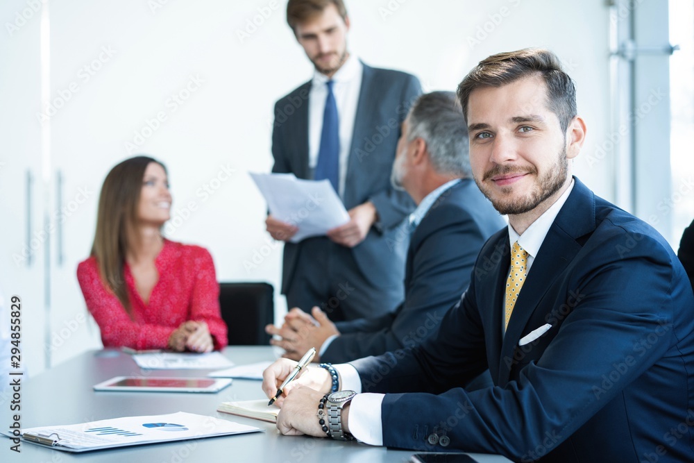 Businessman sitting in board room during new project discussion. Businessman sitting in board room during new project discussion.